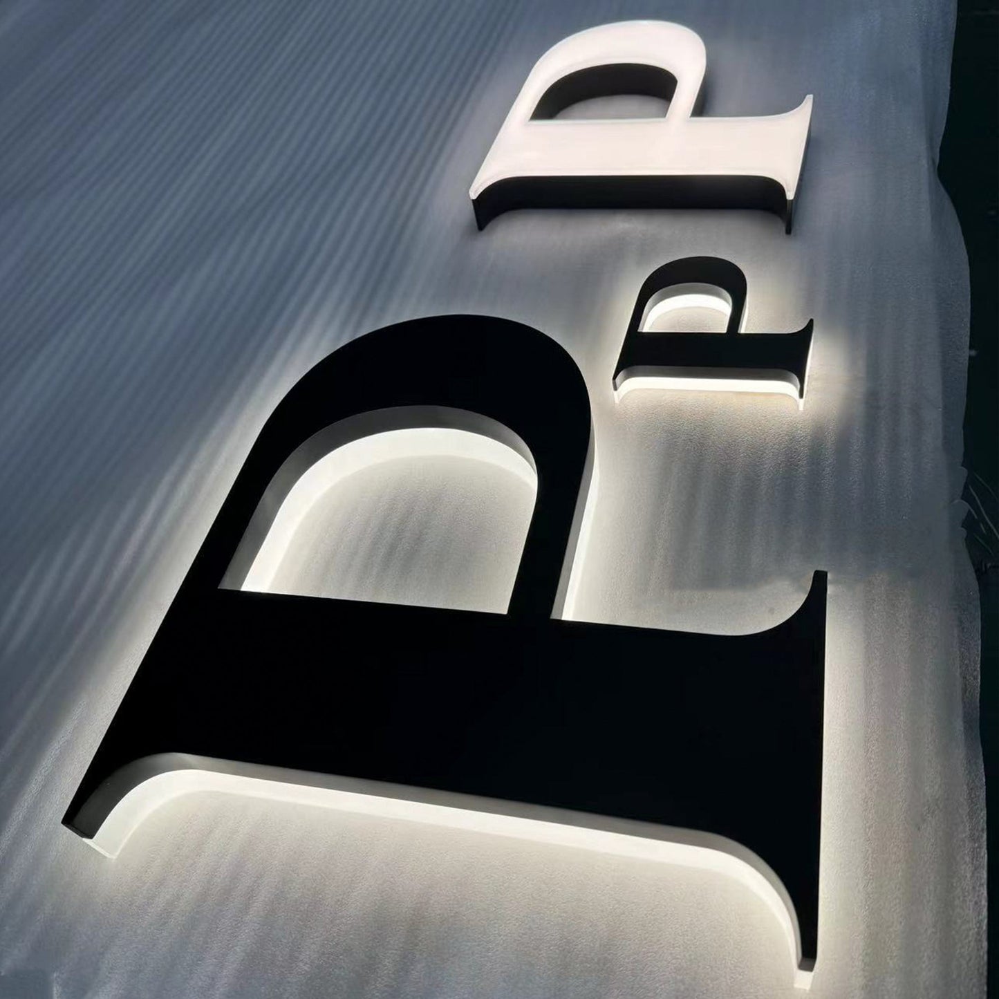 Custom painted stainless steel 3D letters reverse lit channel letters exterior company wall brand signs